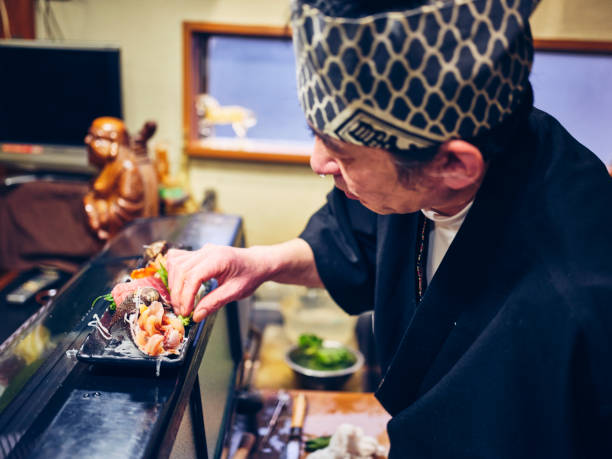 istock Japanese Sushi Chef in a Sushi Shop 1163581123