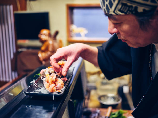 istock Japanese Sushi Chef in a Sushi Shop 1163581285