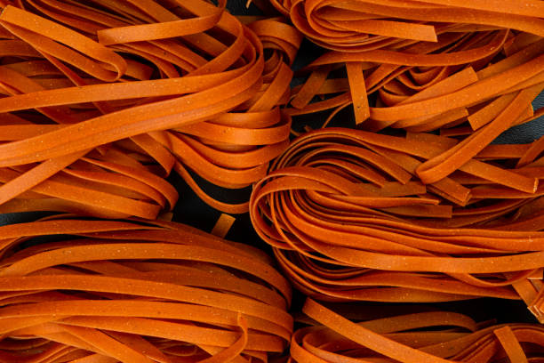 detail of natural carrot noodles. ready for cooking - british indian ocean territory imagens e fotografias de stock