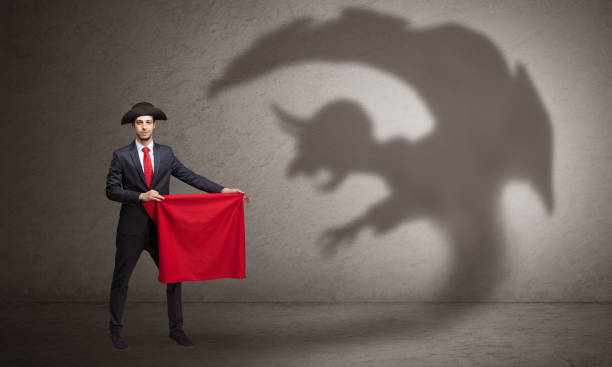 istock Businessman with imp shadow and toreador concept 1163585541