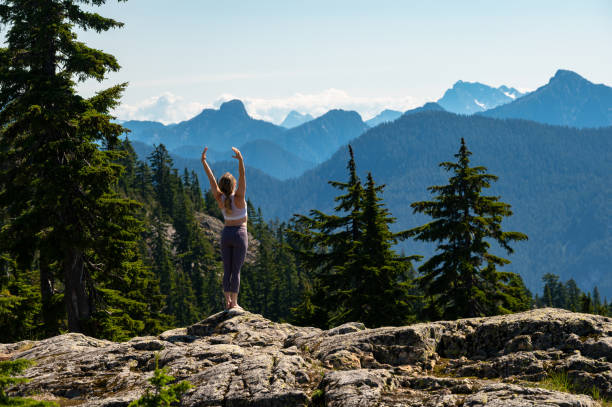 istock Woman practicing yoga in the mountains 1163586950