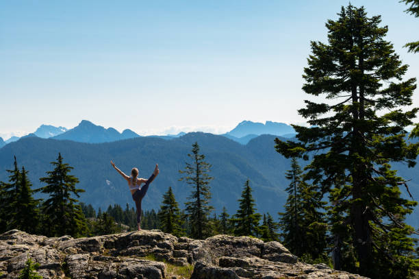 istock Woman practicing yoga in the mountains 1163586957