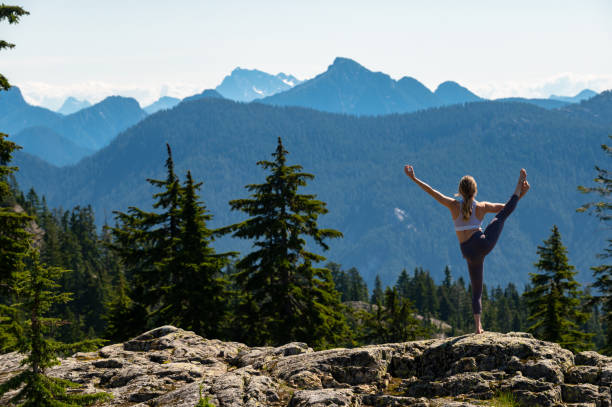 istock Woman practicing yoga in the mountains 1163586963