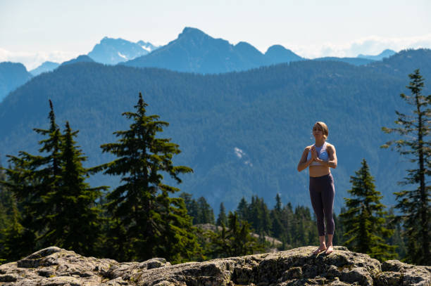 istock Woman practicing yoga in the mountains 1163586971