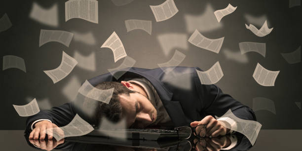 istock Businessman fell asleep at the office with paperwork concept 1163587004