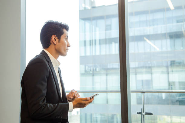 istock Businessman looking out the window 1163587038
