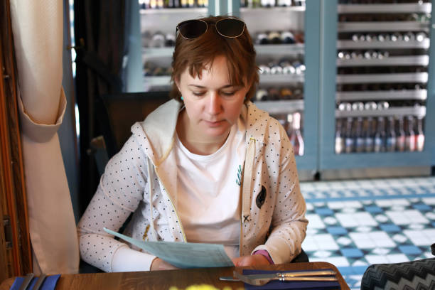 istock Woman with menu in restaurant 1163588164
