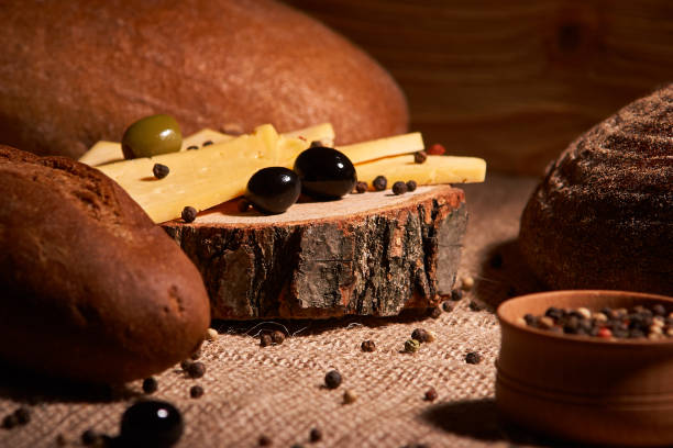 istock Slices of cheese on wooden desk between different breads. place for text 1163592655