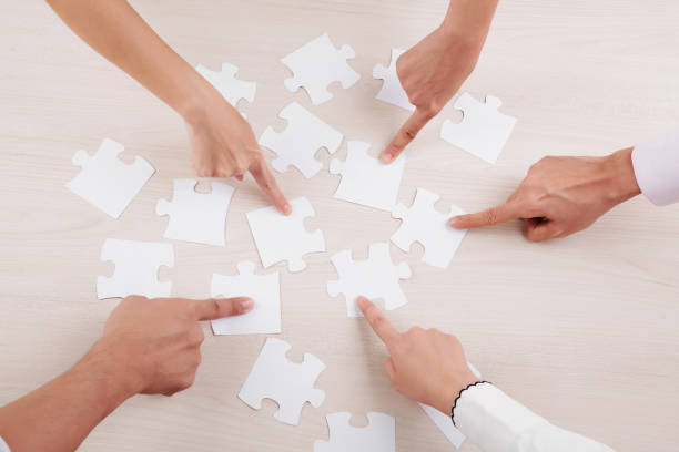 istock Group of people collecting puzzles 1163592906