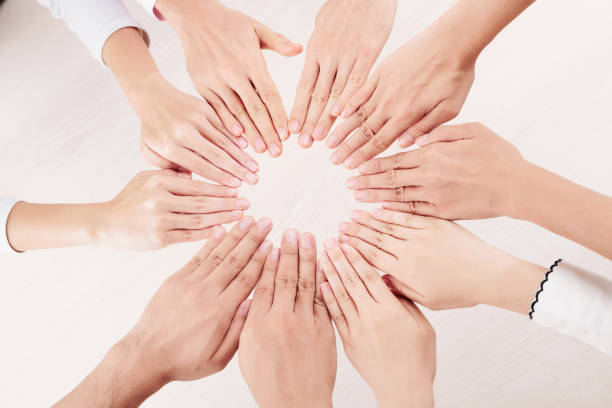 istock Group of people making sun from hands 1163592915