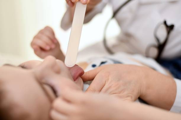 the doctor examines the mouth, throat. - lip liner fotos imagens e fotografias de stock