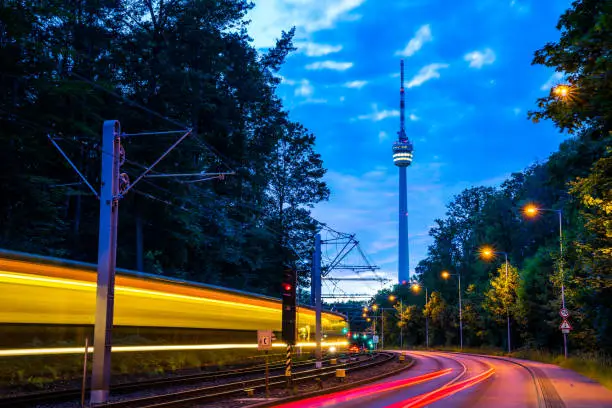 Germany, Stuttgart city television tower and magical lights of driving cars and tramway traffic in twilight mood after sunset in summer