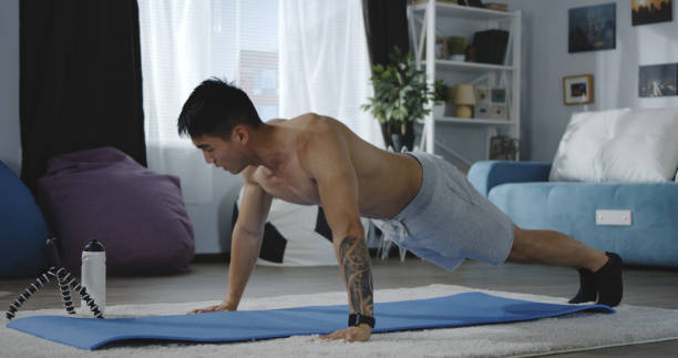 istock Young man working out at home 1163595492