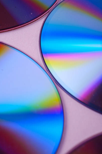 istock Abstract CD DVD compact disc disk dispersion refraction reflection of light colors texture on pink background close up 1163595539