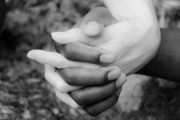 istock A womans hand holding a mens hand 1163595851
