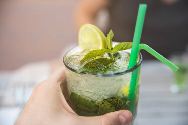 istock summer ice cocktail with mint in the hands 1163596684