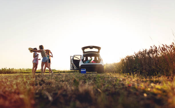 istock Cheerful girls having fun in sunset while traveling 1163598209