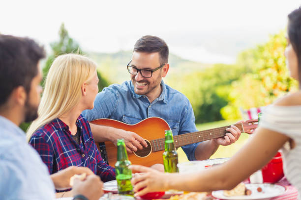 istock Playing the guitar at backyard party 1163599453
