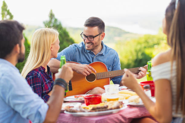 istock Playing the guitar at backyard barbecue party 1163599466