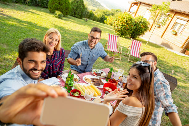 istock Friends taking selfies at barbecue party 1163599832