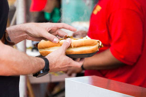 istock Person Getting Hot Dog from a Vendor 1163603921