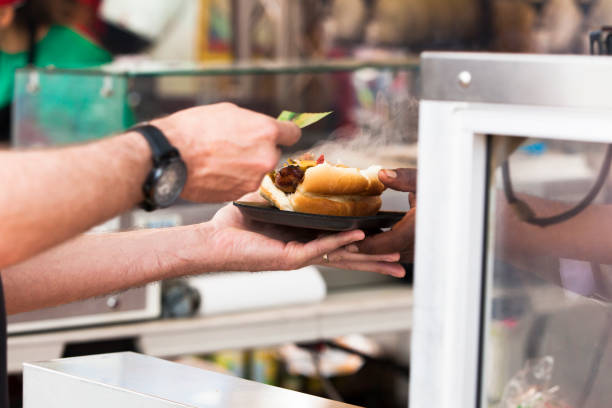 istock Person Getting Hot Dog from a Vendor 1163603968