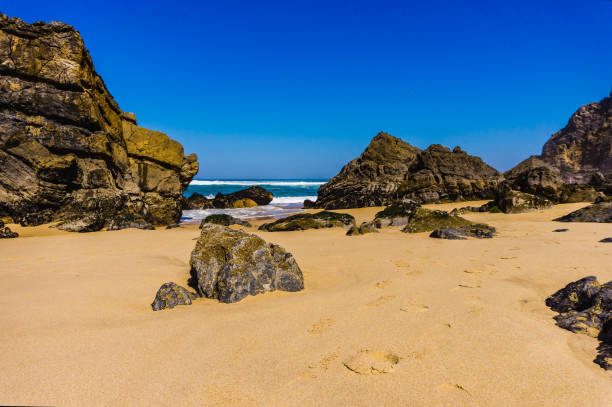 istock Portugal's sandy beach on rocky Atlantic coast. 1163605841