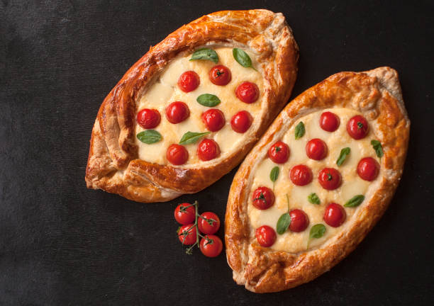 istock Traditional Turkish baked pide dish. Middle Eastern snacks. Turkish pizza. Pide with cheese. Open pie with cheese. The view from the top. Copy space. 1163605992