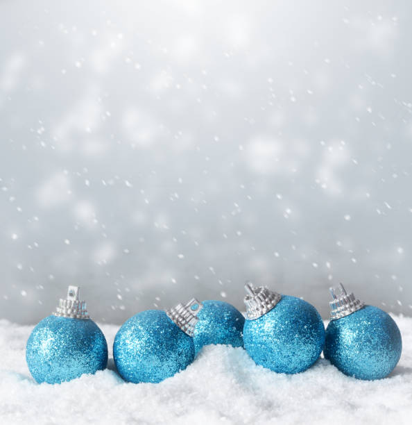 istock Color shiny christmas balls in snow background 1163608986