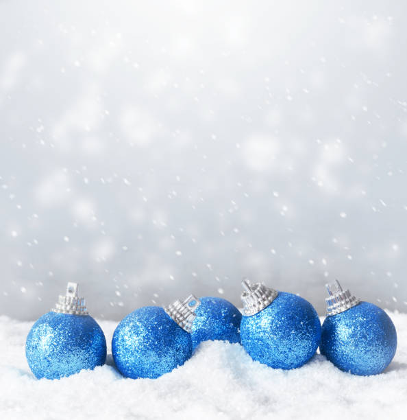 istock Color shiny christmas balls in snow background 1163609018