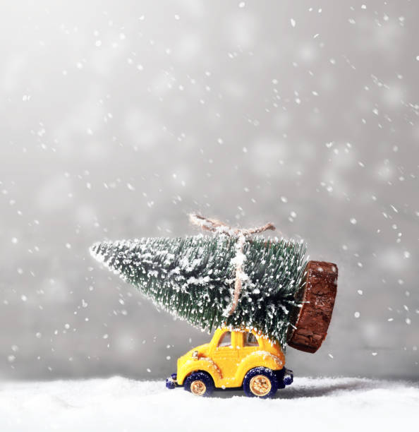 Christmas tree on toy car. Christmas holiday celebration concept.