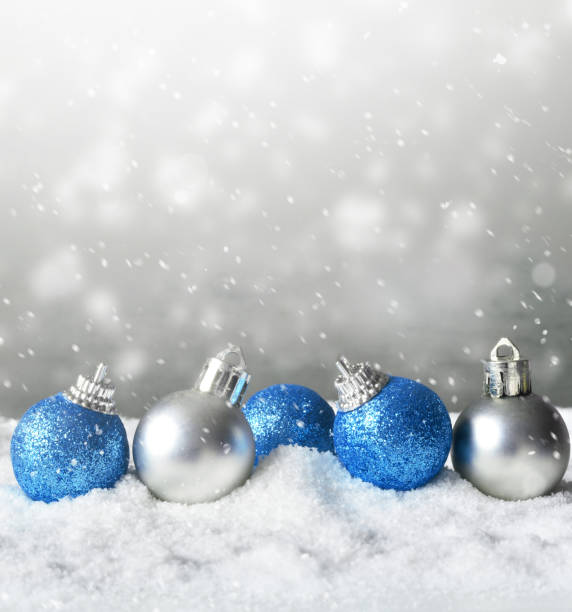 istock Color shiny christmas balls in snow background 1163609150
