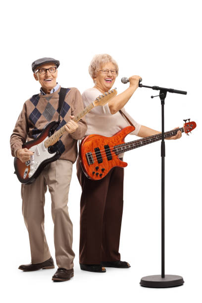 istock Senior couple with electric guitars singing on a microphone 1163613172