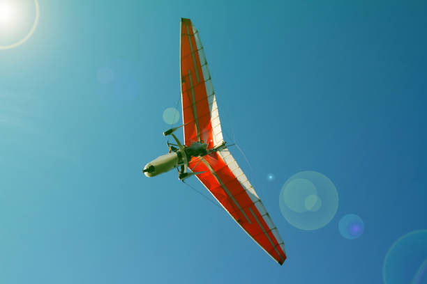 istock Bottom view super lightweight hang glider or trike flies in clear blue sky 1163613195