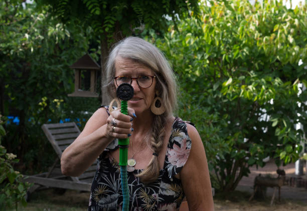 istock Woman watering the garden 1163613429