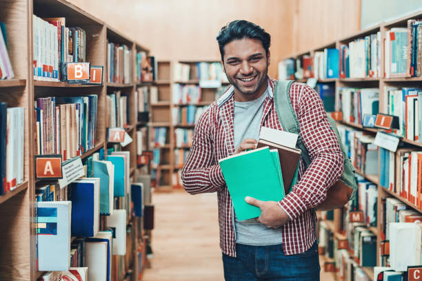 istock Portrait of a smiling student in a library 1163614687