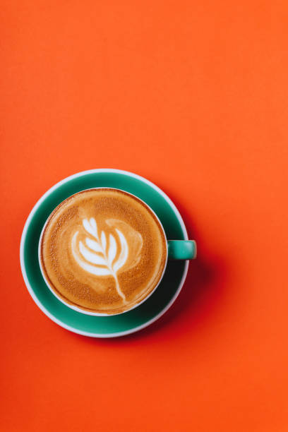 cyan coffee cup over orange background. - coffee cup isolated cappuccino multi colored imagens e fotografias de stock