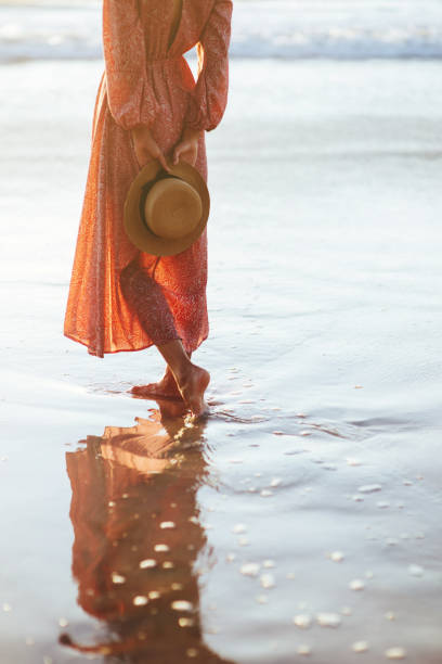 istock Young woman running on seaside path. 1163618810