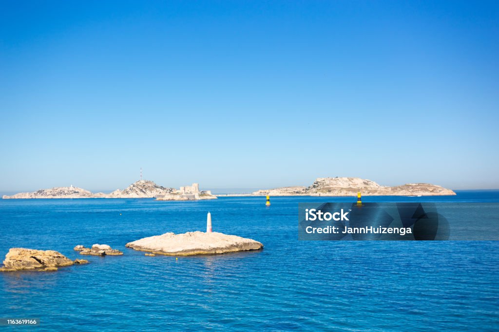 Marseille, France: Sunny Frioul Islands, Chateau d'If Marseille, France: Sunny Frioul Archipelago, with the Chateau d’If in the distance. Plenty of copy space in the vibrant blue sky or sea. Shot from the Endoume neighborhood. Archipelago Stock Photo