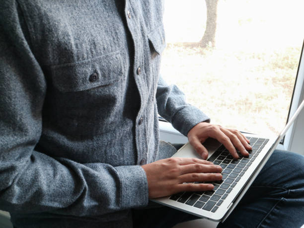istock Man seated near to the window studying 1163620435