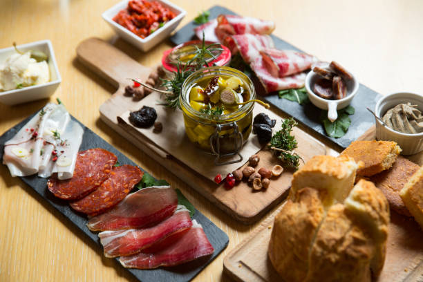 istock different kinds of cut ham on a wooden board 1163620480