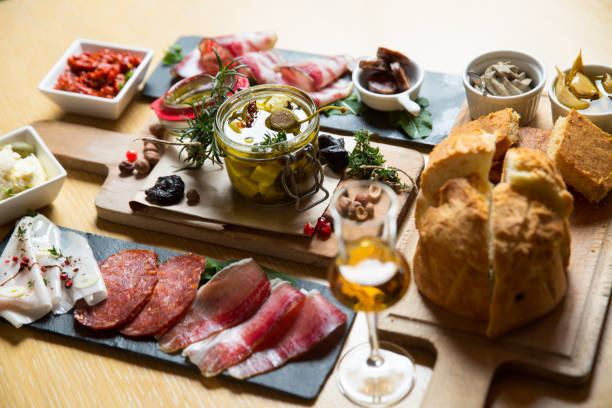istock different kinds of cut ham on a wooden board 1163620537