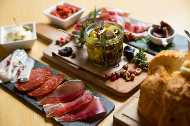 istock different kinds of cut ham on a wooden board 1163620601