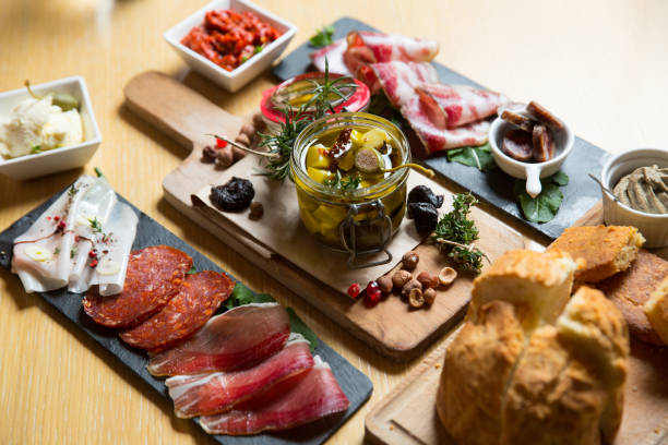 istock different kinds of cut ham on a wooden board 1163622291