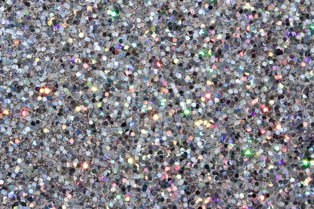 istock Defocused macro abstract background of sparkling silver glitter texture 1163622495