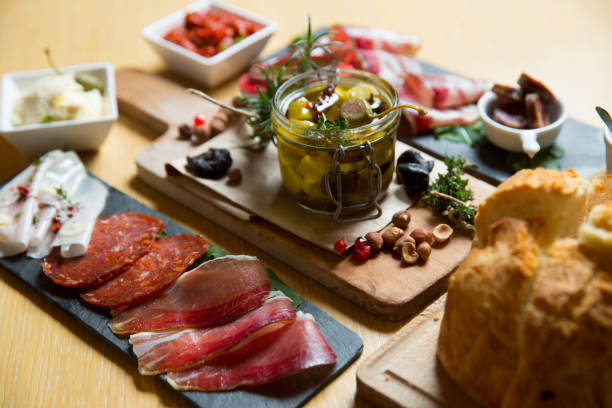 istock different kinds of cut ham on a wooden board 1163623341
