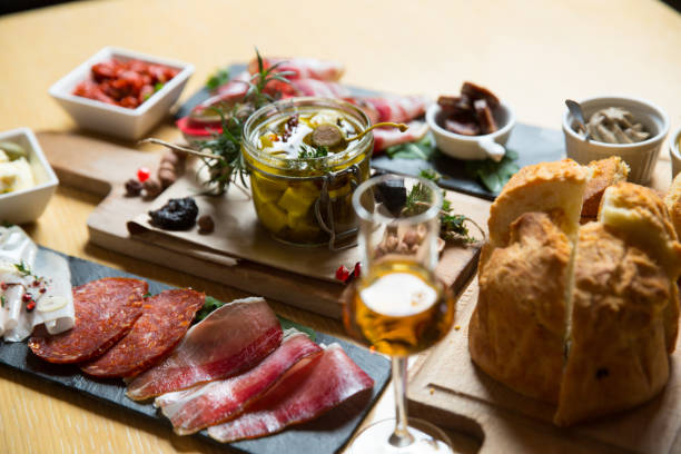 istock different kinds of cut ham on a wooden board 1163623352
