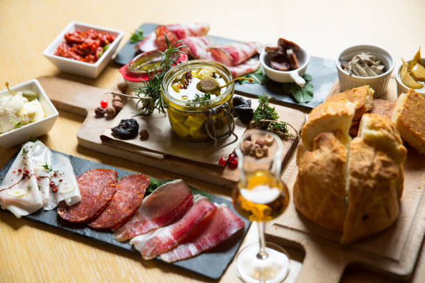 istock different kinds of cut ham on a wooden board 1163623371