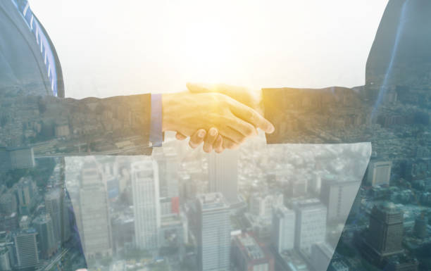 istock double exposure of handshake, success and partner concept 1163624278