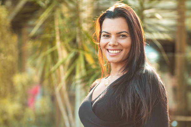 istock Young woman smiling at sunset 1163627911